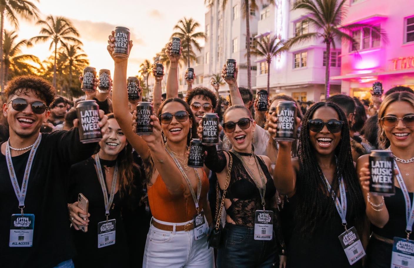 Fans at Latin Music Week raising branded cans at sunset in Miami Beach